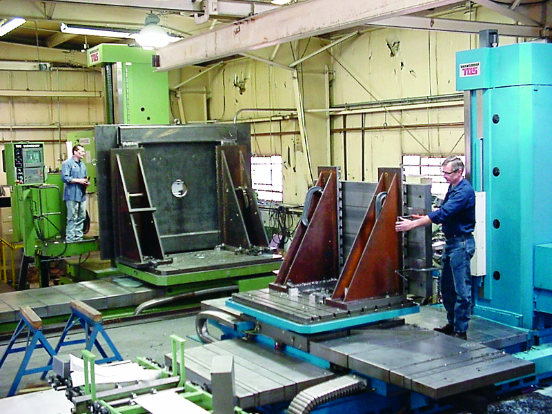 UTRS AM technician next to a boring mill machine