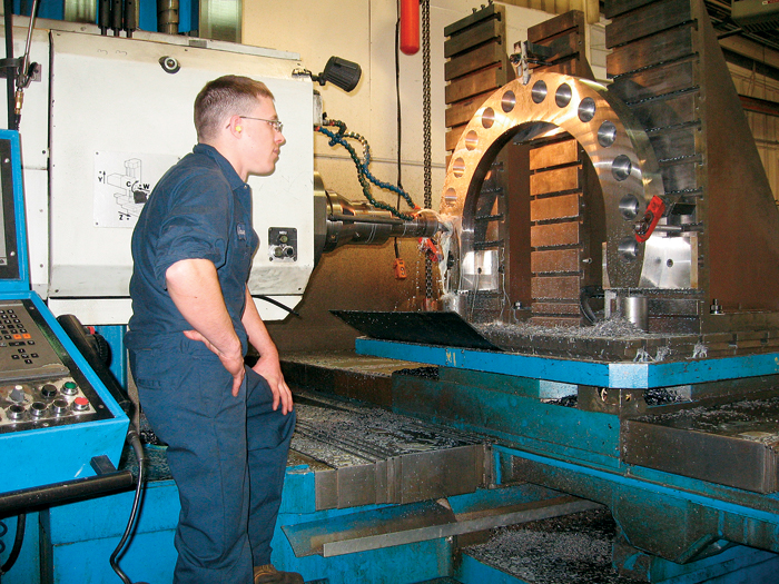 UTRS AM technician using a boring mill machine