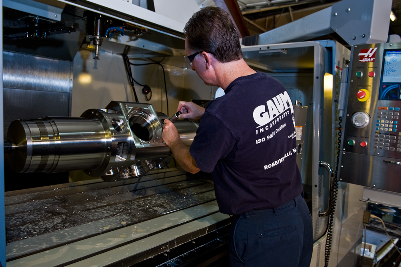 UTRS AM technician using a large part milling and turning machine.