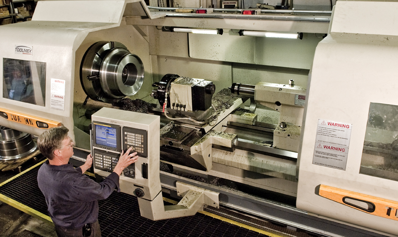 UTRS AM technician working a CNC turning machine