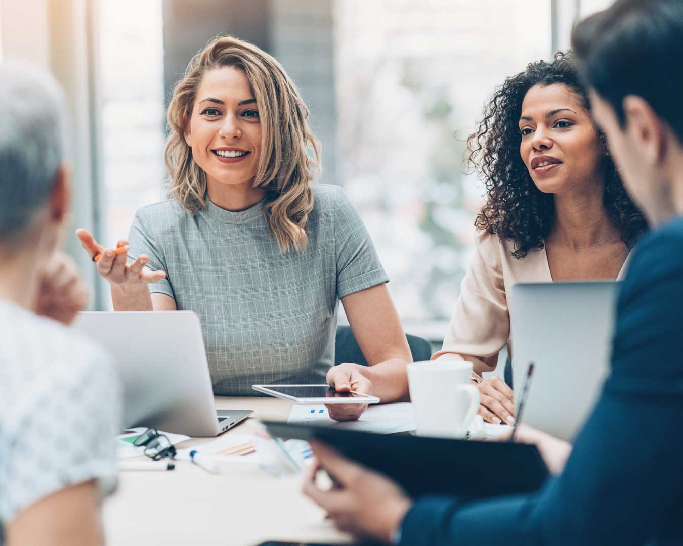 Female manager discussing business to group of people