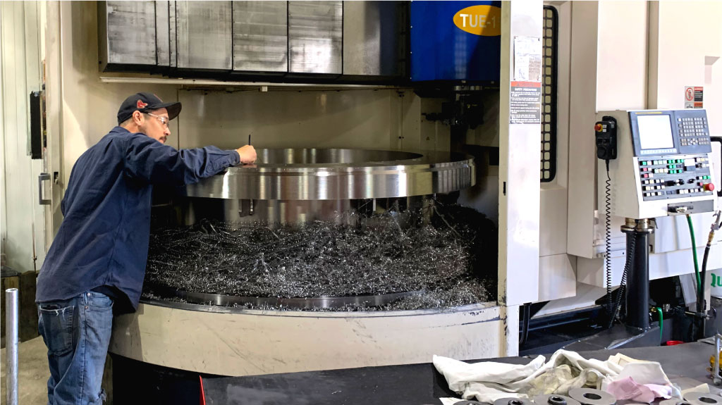 UTRS AM employee using a TUE-15 CNC Vertical Boring Mill