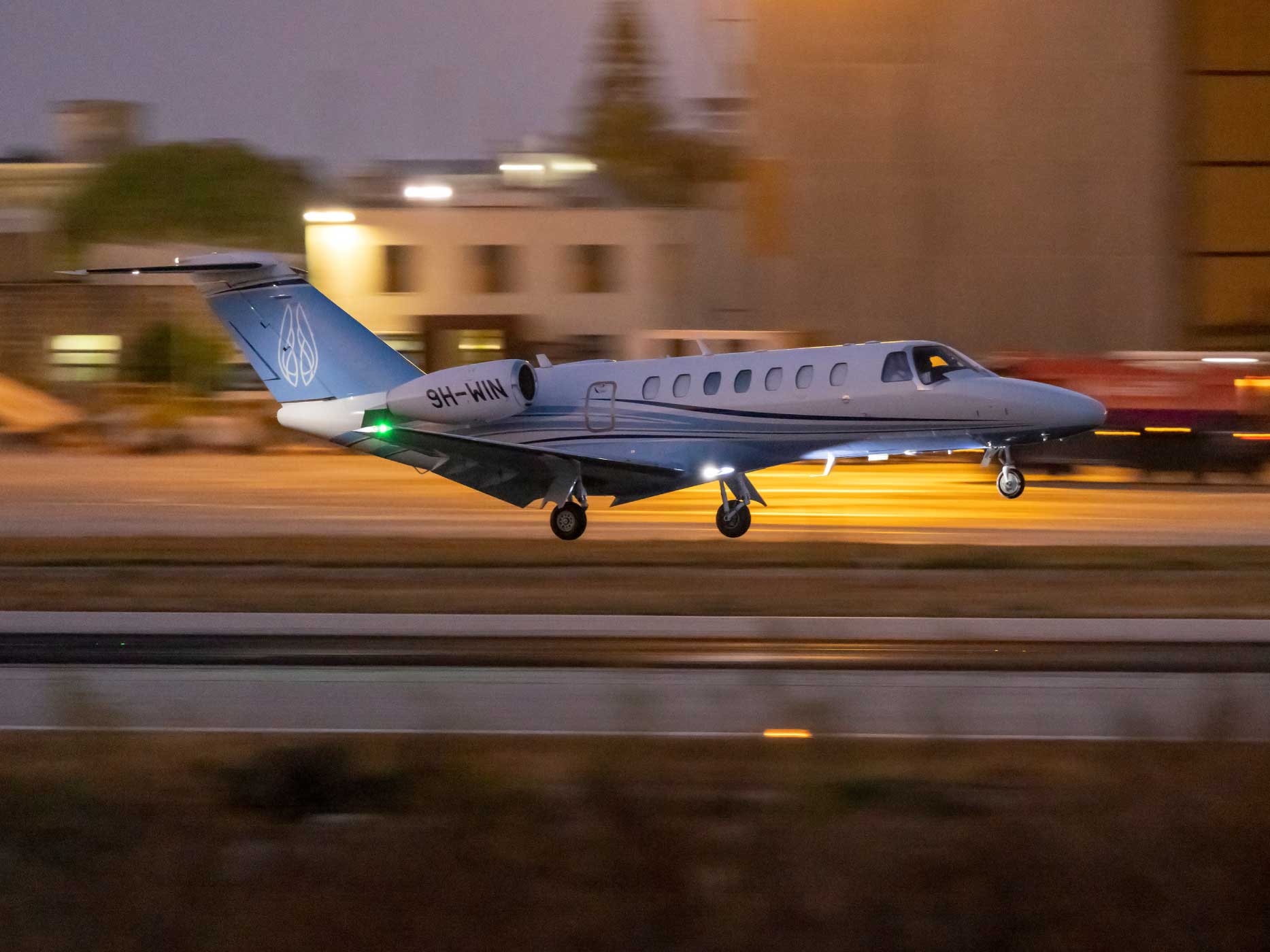 Air Charter Cessna 525B Citation CJ3+ landing on runway after sunset.