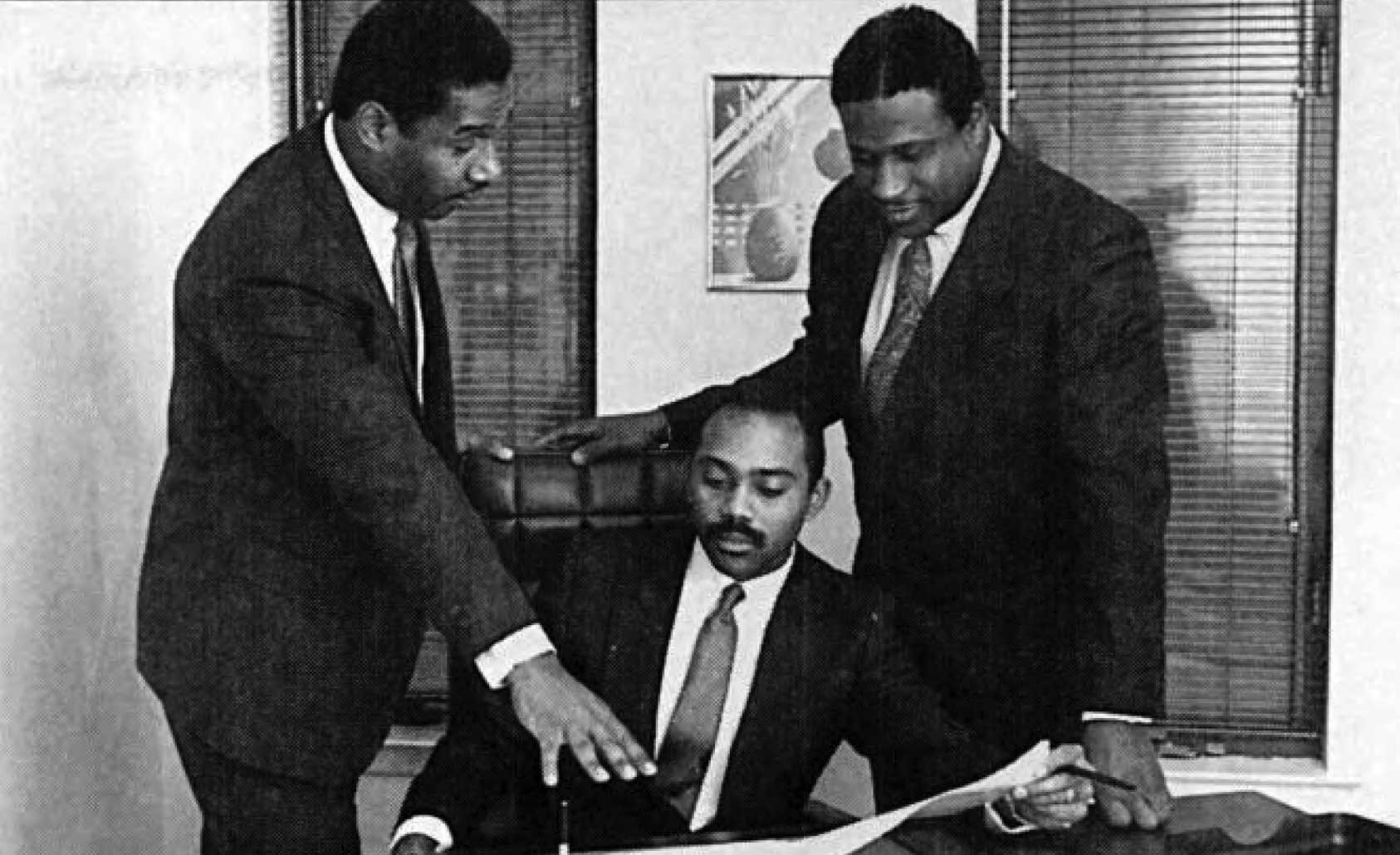 UTRS founders Lamont McLean (seated) and Gerry Wright (right), with Lloyd Booker, UTRS VP of Technical Services, in 1987.