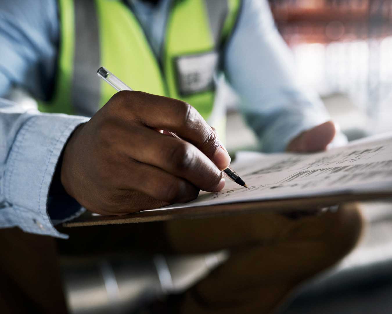 Engineer filling out paperwork at a construction site