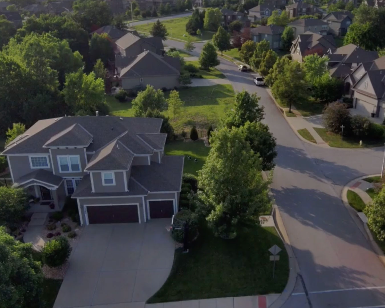 Aerial view suburban residential street with rows of upscale two-story houses and planned community